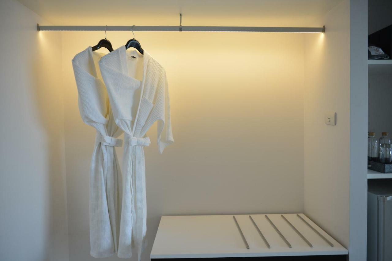 Le D'Tel Bangkok Hotel Exterior photo A bathrobe hanging on a hanger